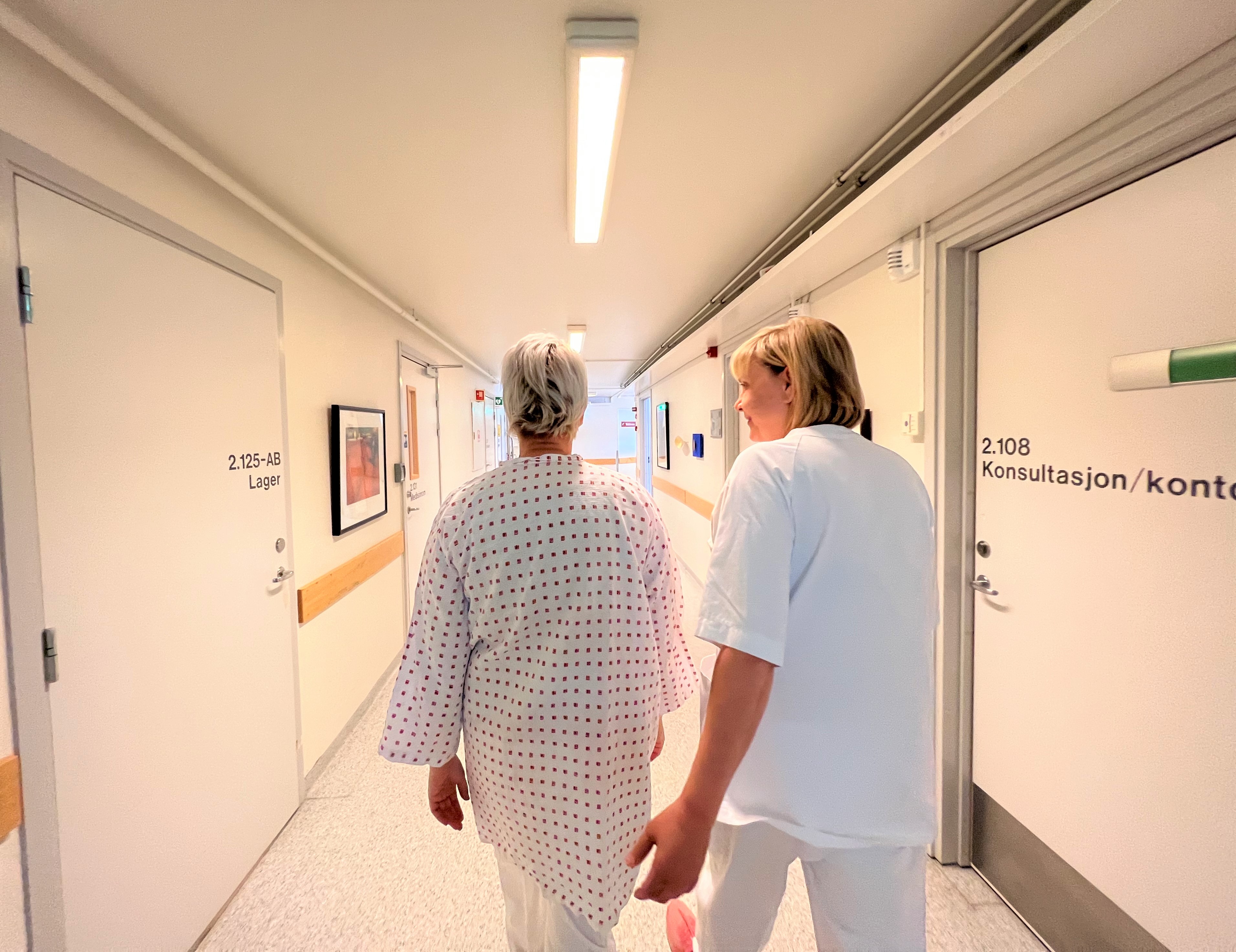 A couple of women walking down a hallway