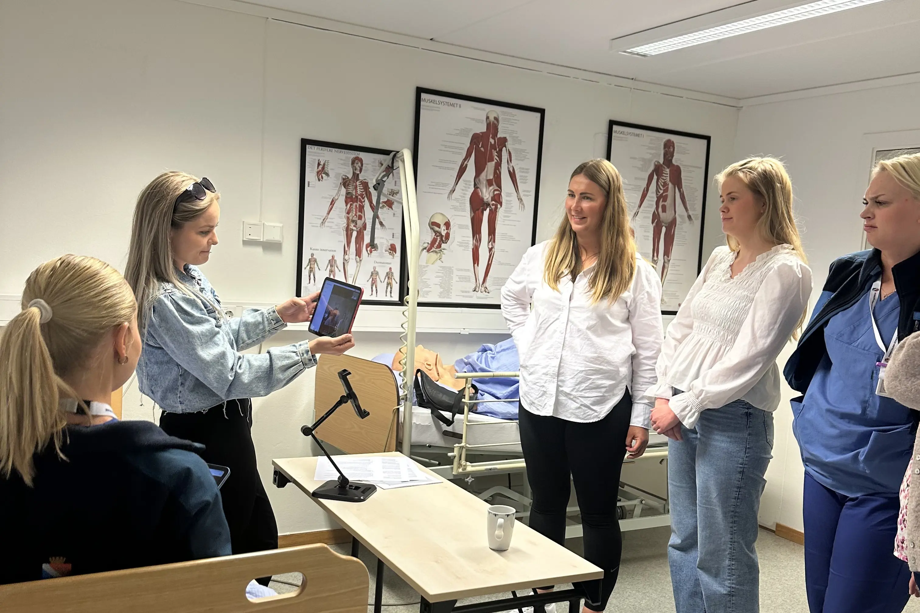Ansatte i kommune og sykehus som ser på det digitale utstyret