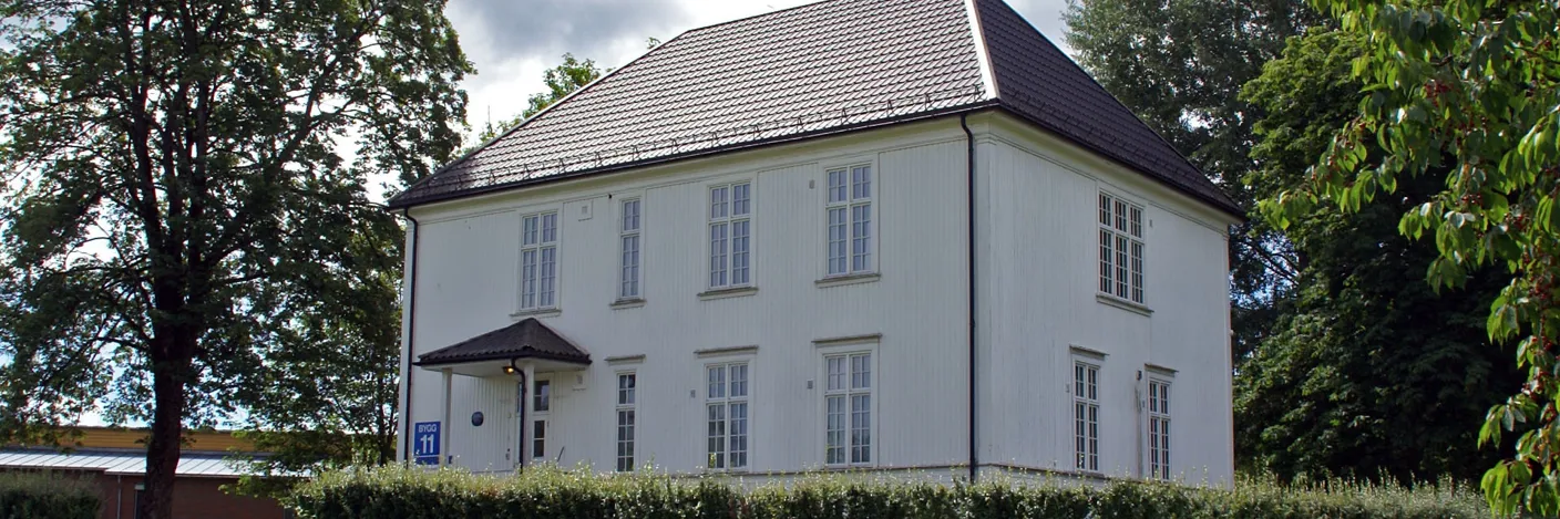 Et hvitt hus med en plen foran seg